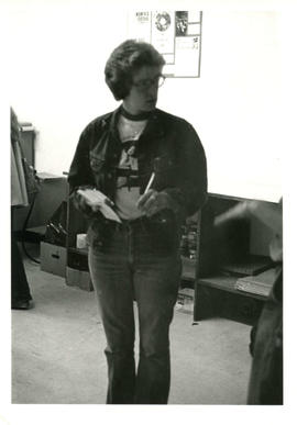 Amazon Print Shop interior view with unidentified woman standing holding pen and paper, Toronto