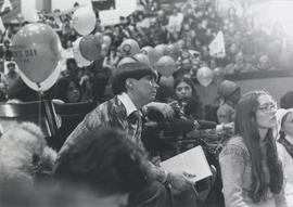 View of woman leaning forward in her chair in the University of Toronto's Convocation Hall attend...