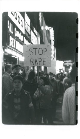 Woman holding "Stop Rape" sign  during a Take Back the Night demonstration, Toronto