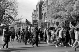People protesting and holding banners in front of the Ontario Legislative Building. Toronto, 1988.