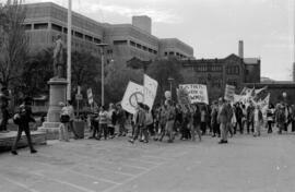 Protestors walking and holdings signs. Toronto, 1988.
