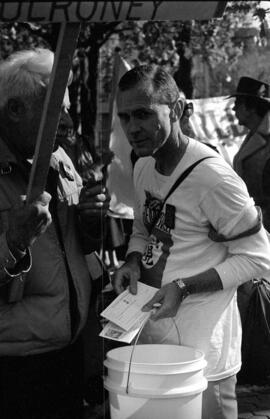 Portrait of a man in white holding a bucket. Toronto, 1988.