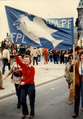 Individuals holding WILPF banner on Parliament Hill