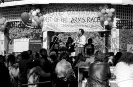 A bearded musician singing in front of a crowd, at the TDN demonstration, Toronto, 1988.