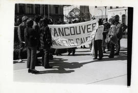 Women carrying a "Vancouver Women's Caucus" banner in front of a building, [Vancouver]