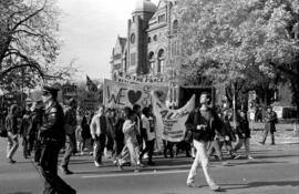 People protesting and holding banners in front of the Ontario Legislative Building. Toronto, 1988.