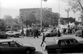 A crowd of people protesting near a parking lot. TDN demonstration, Toronto, 1988.