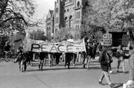 Protestors holding a "Students For Peace" banner, walking in front of the Ontario Legislative Bui...