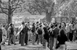 A group of people holding: "Anglican Peace[maker]" and "He Is The Peace Between Us" signs