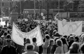 A crowd of people, holding signs near a statue at an intersection. TDN demonstration, 1988.
