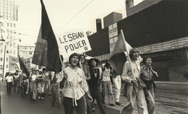 Women demonstrators marching  holding flags and  "Lesbian Power" sing during Body Politic Demonst...