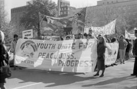 Protesters holdings signs and banners in the street. Toronto, 1988.