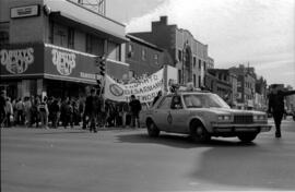 Protesters walking in front of Druxy's Famous Deli. Toronto, 1988.