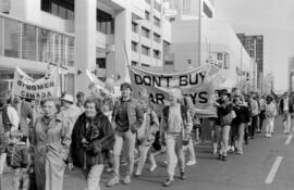 Protestors holding signs in the street. Toronto, 1988.