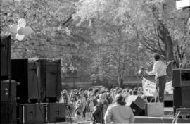 Back view of a musician in a gazebo, facing a crowd.  At a TDN demonstration, 1988.