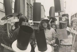 Close up view of people marching holding "Negotiate." "Unite and fight for women's rights" and "S...