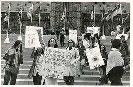 Demonstration in front of Parliament Hill with women carrying "Sin[g] Sister, Canadian Women's Co...
