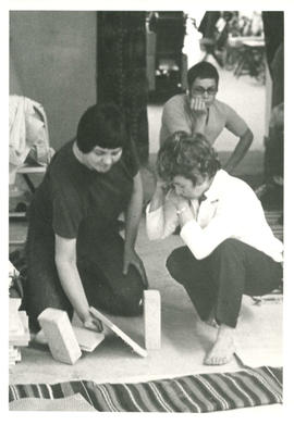 Woman practicing breaking wooden boards with teacher during self-defence class at the Amazon Self...