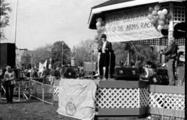 Man wearing a black suit and a fedora speaking at the TND demonstration, Toronto, 1988.