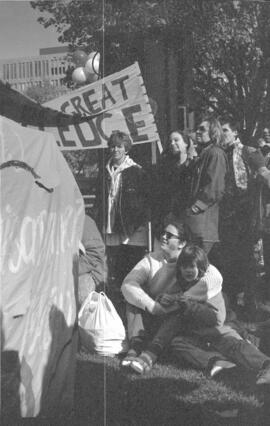 A group of people gathered in a park. Toronto, 1988.