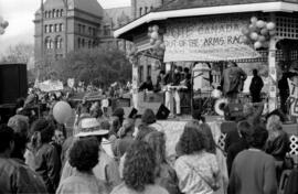 Crowd watches a band on a gazebo in front of the Ontario Legislative Building. Toronto, 1988.
