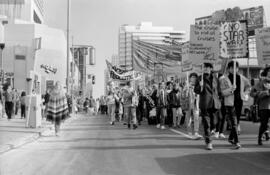 Protesters holding signs in the street. Toronto, 1988.